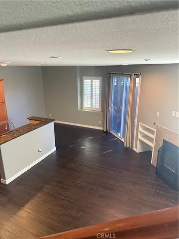 a view of kitchen with furniture and wooden floor