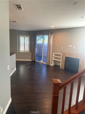 a view of a hallway with wooden floor and entryway