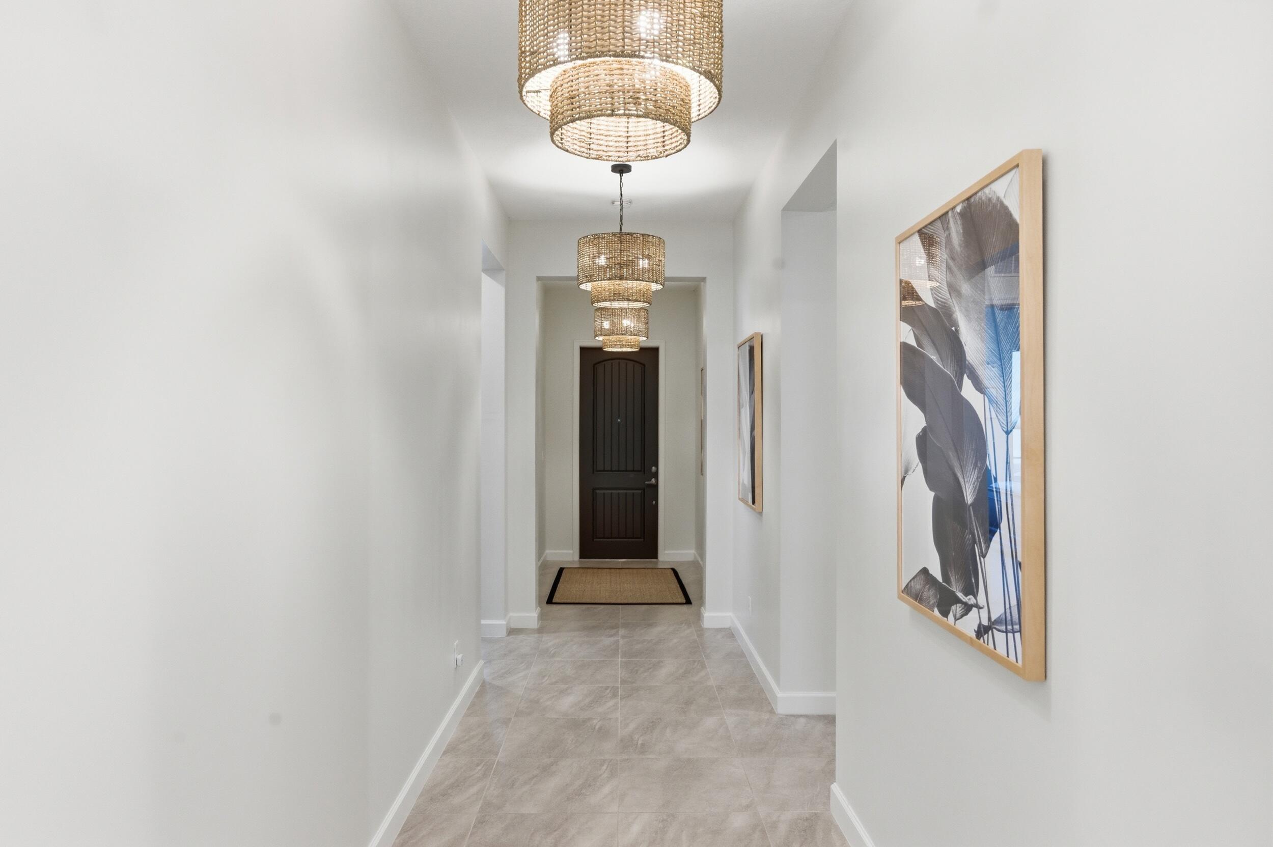19230 Rolling Acres Road Loxahatchee, FL 33470 - Photo 24 of 58 a view of a hallway with front door