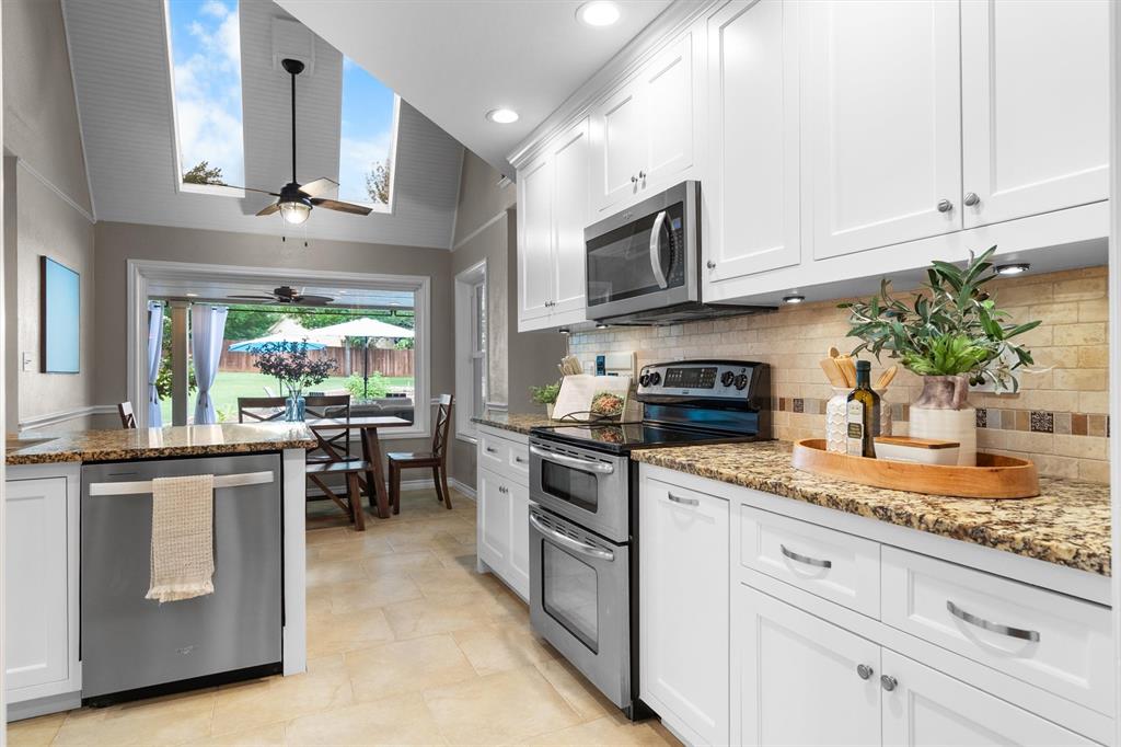 410 Simmons Road Double Oak, TX 75077 - Photo 14 of 40 Stainless appliances, tile backsplash, and ample counter space make this kitchen shine.