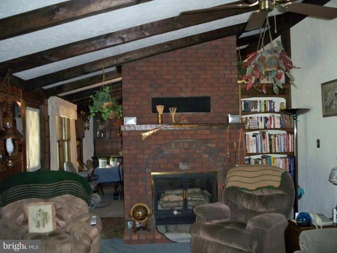 11902 Beaver Dam Road Union Bridge, MD 21791 - Photo 14 of 25 a living room with furniture and a fireplace
