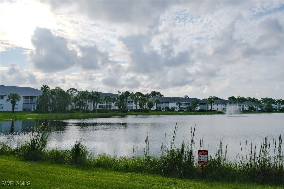 345 Gabriel Circle, Unit 2411 Naples, FL 34104 - Photo 13 of 13 a view of a lake with houses in background
