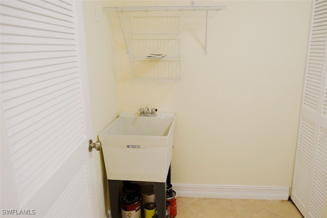 345 Gabriel Circle, Unit 2411 Naples, FL 34104 - Photo 8 of 13 a utility room with a sink