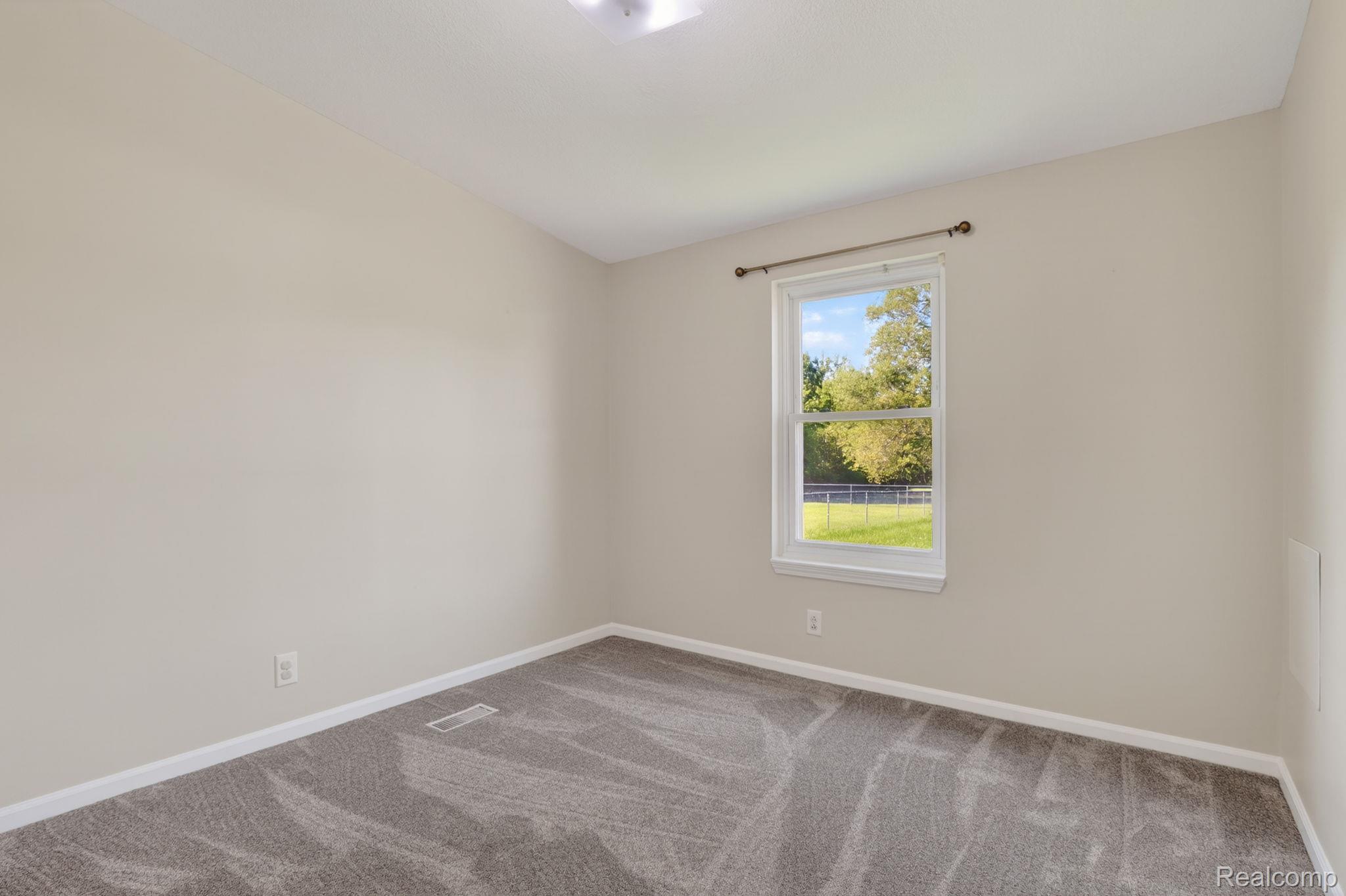 4050 West Thompson Road Linden, MI 48451 - Photo 25 of 36 Unfurnished room with baseboards and light colored carpet