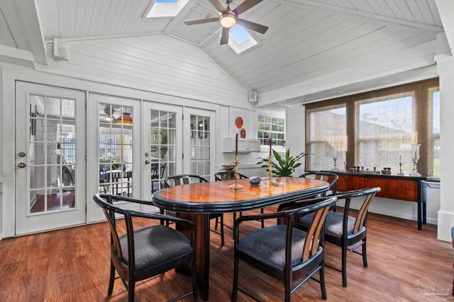 a dining room with furniture a chandelier and wooden floor