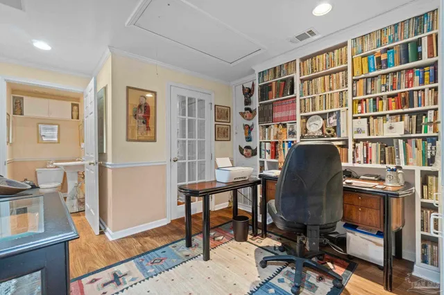 a view of a workspace with furniture and a bookshelf