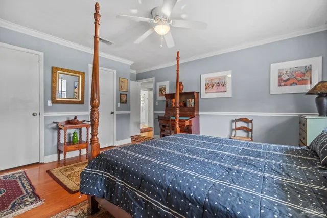 a bedroom with a bed and a bookshelf