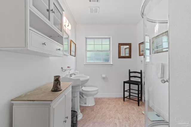a bathroom with a sink toilet and shower