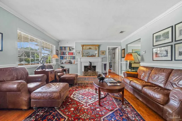 a living room with furniture fireplace and a window