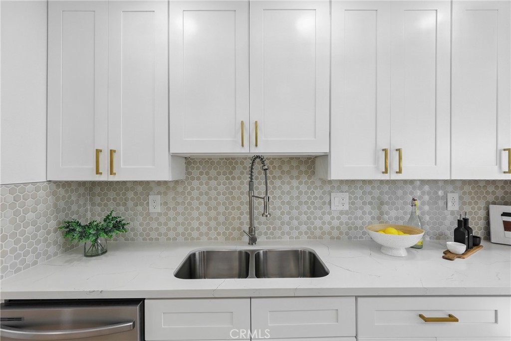 9431 Cypress Avenue Riverside, CA 92503 - Photo 12 of 40 a kitchen with a sink a counter and cabinets