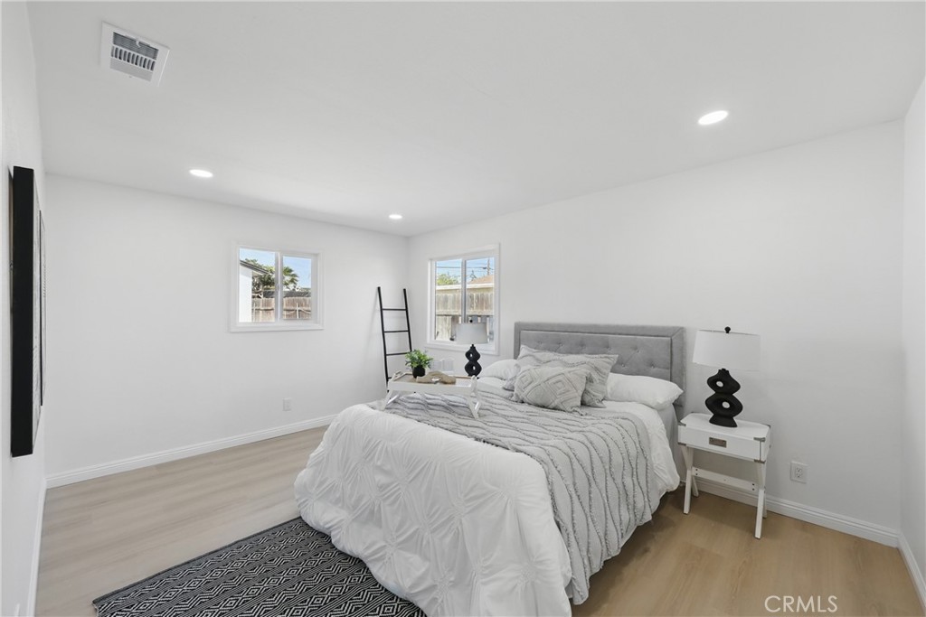 9431 Cypress Avenue Riverside, CA 92503 - Photo 19 of 40 a bedroom with a bed and a painting on the wall