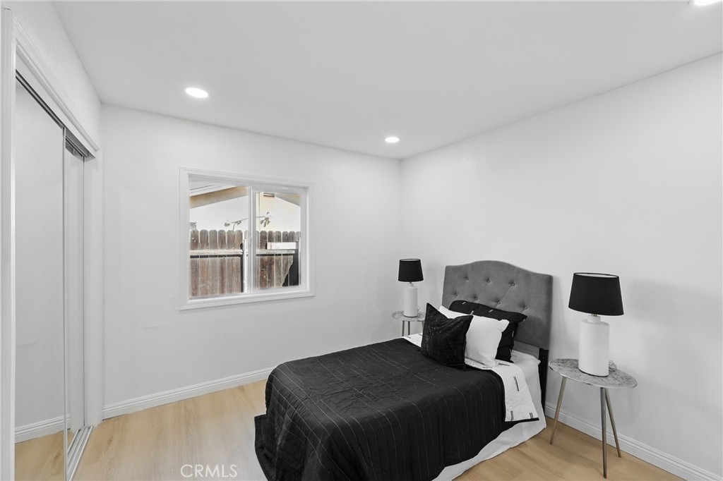 9431 Cypress Avenue Riverside, CA 92503 - Photo 23 of 40 a bedroom with a bed and wooden floor