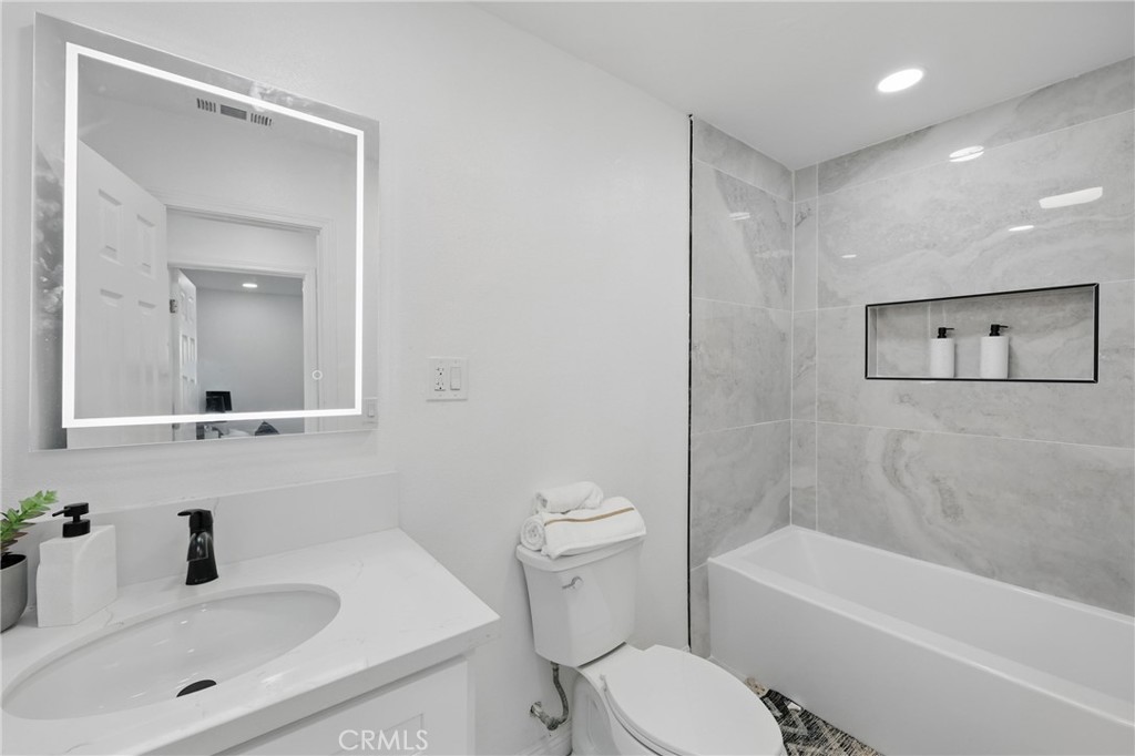 9431 Cypress Avenue Riverside, CA 92503 - Photo 26 of 40 a bathroom with a sink a toilet and shower