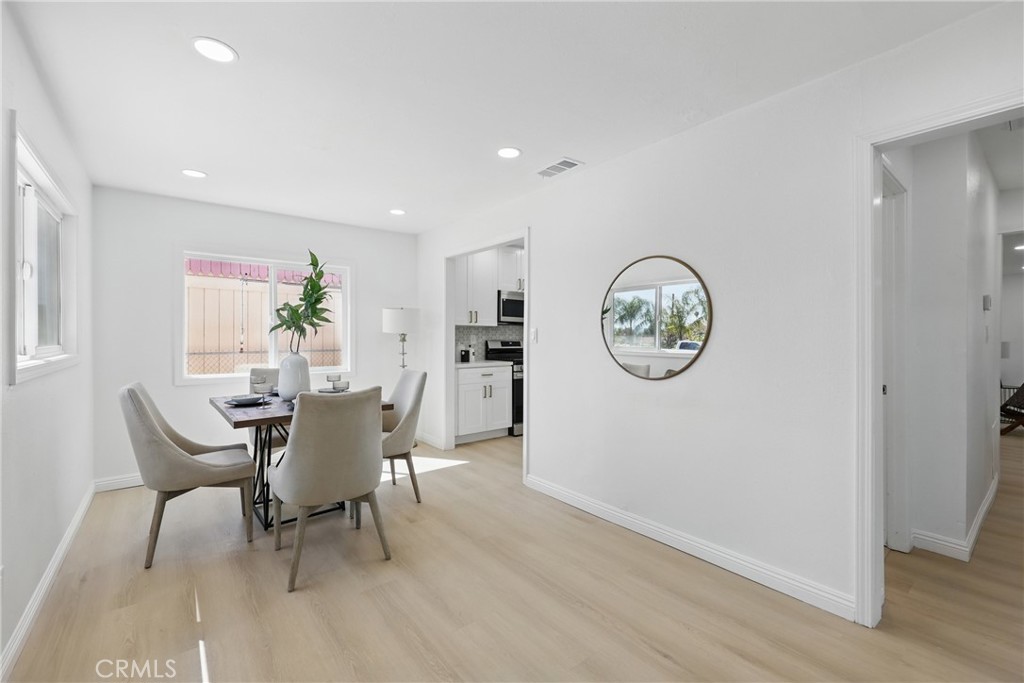 9431 Cypress Avenue Riverside, CA 92503 - Photo 6 of 40 a view of a dining area with furniture window and wooden floor
