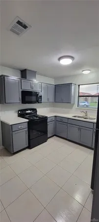 a kitchen with stainless steel appliances granite countertop a sink and a stove
