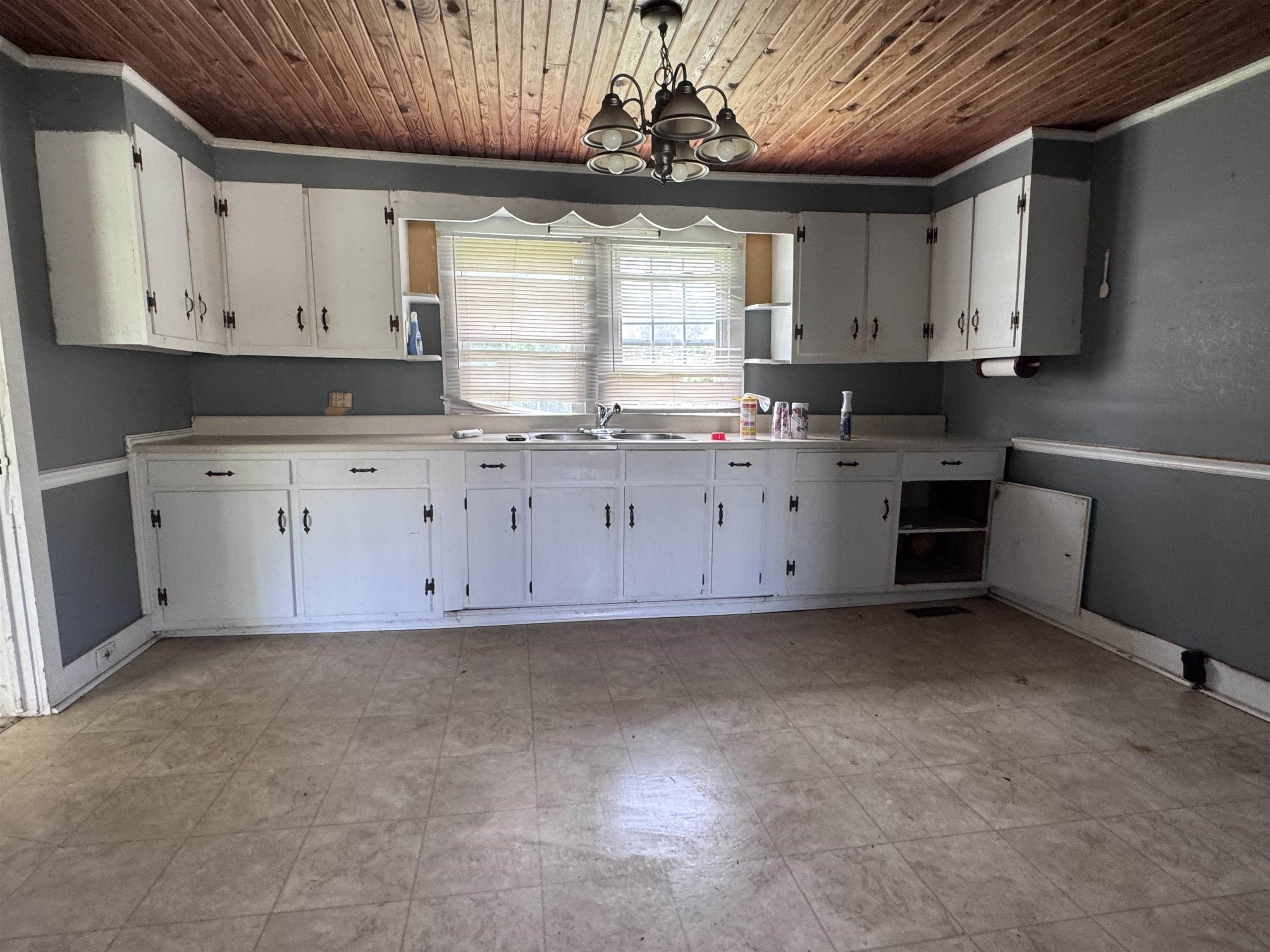 237 Old Shiloh Road Adamsville, TN 38310 - Photo 3 of 11 a kitchen with granite countertop a sink a stove and cabinets