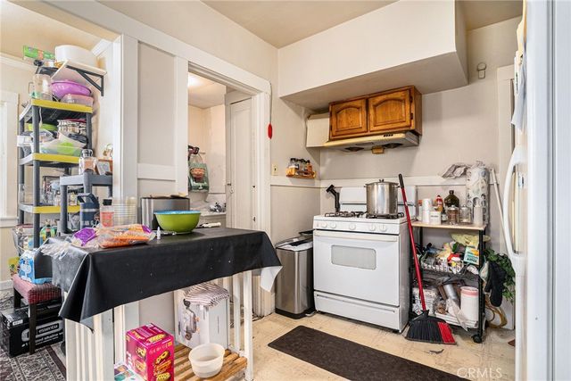 a kitchen with stainless steel appliances a stove a sink and a refrigerator