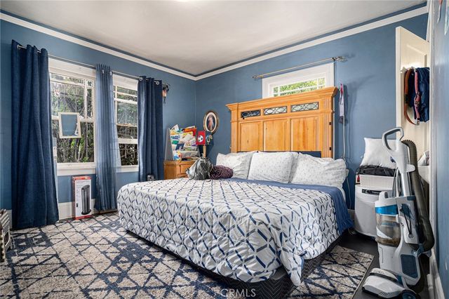 a bedroom with a large bed and a window