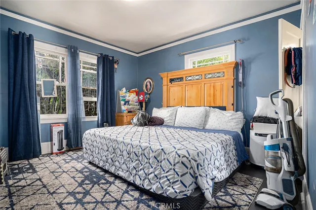 a bedroom with a large bed and a window