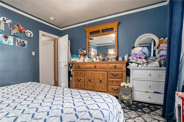 a bedroom with a bed and a dresser