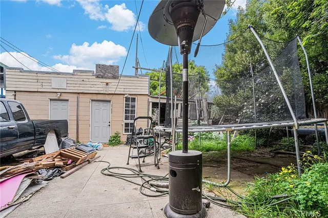 a view of a patio with table and chairs with wooden fence