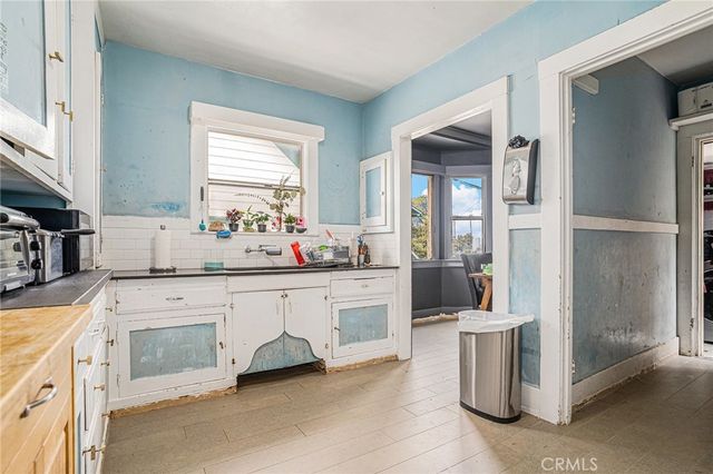 a large white kitchen with cabinets