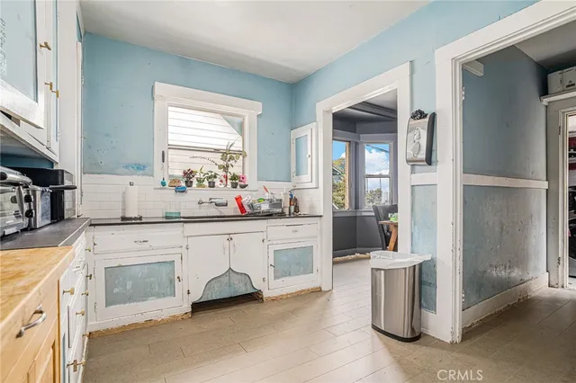 a large white kitchen with cabinets