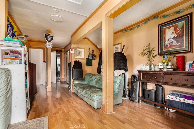 a view of a hallway with wooden floor and furniture