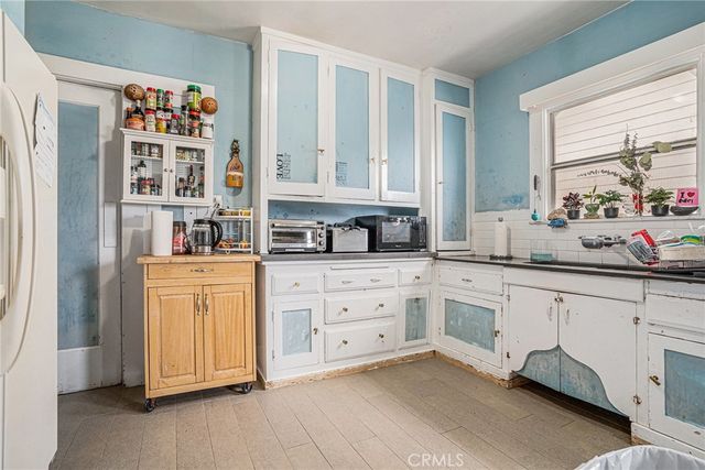 a kitchen with stainless steel appliances cabinets and a window