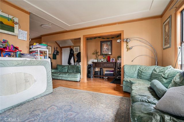 a living room with furniture and a dining table