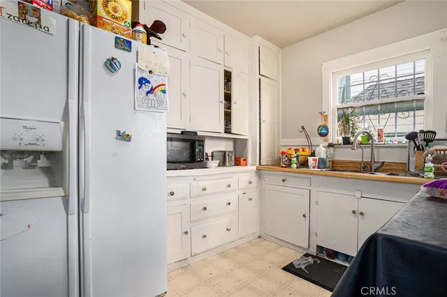 a kitchen with appliances cabinets and a window