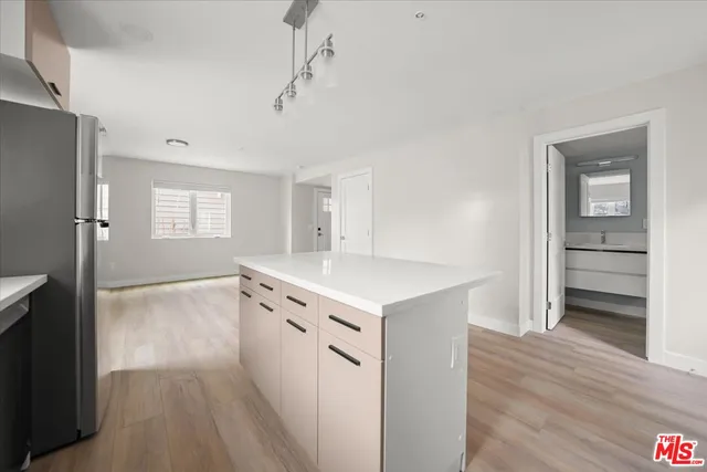 an empty room with wooden floor and a window