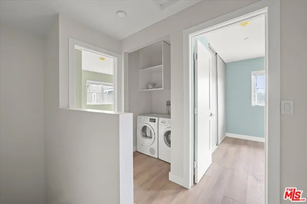 a view of hallway with wooden floor