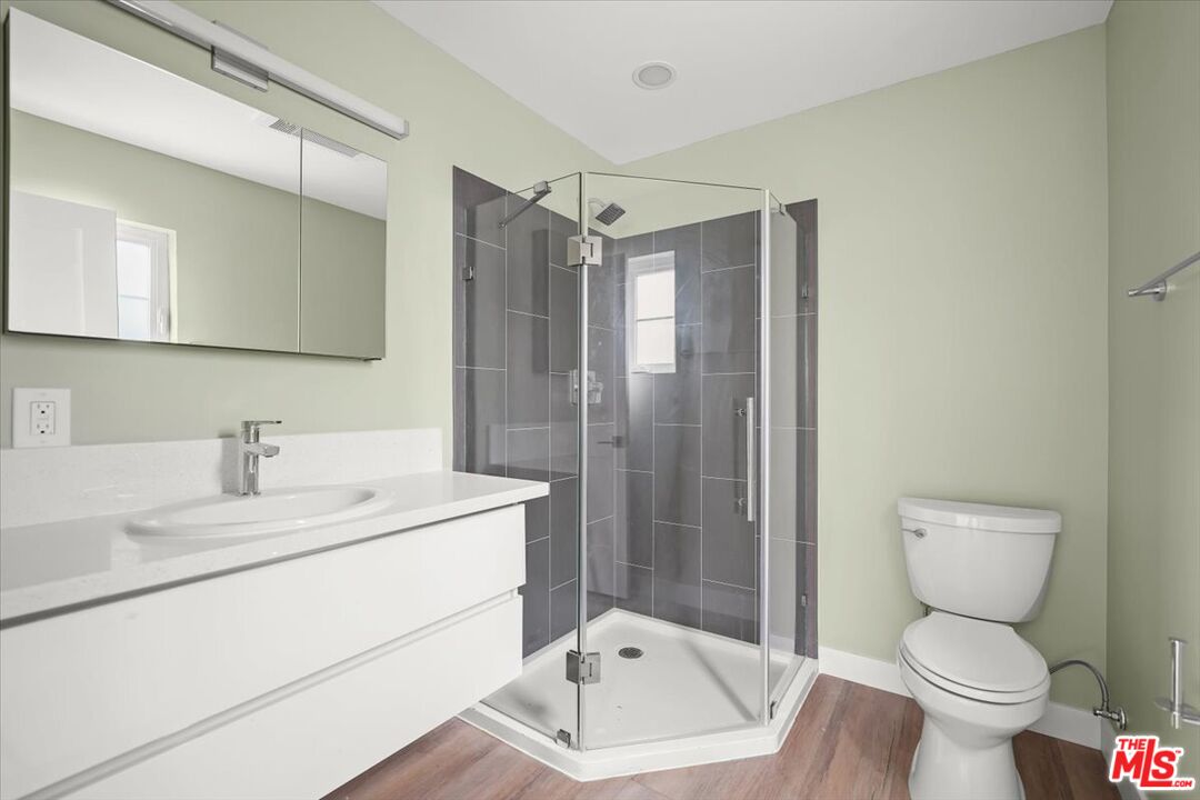 1317 Punta Gorda Street, Unit 3 Santa Barbara, CA 93103 - Photo 18 of 70 a bathroom with a sink toilet vanity and shower