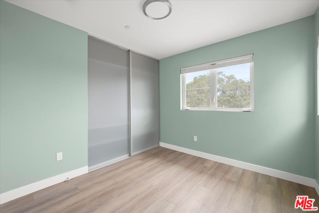 1317 Punta Gorda Street, Unit 3 Santa Barbara, CA 93103 - Photo 21 of 70 an empty room with wooden floor and windows