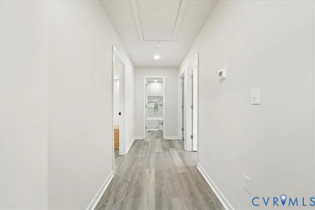 a view of a hallway with wooden floor