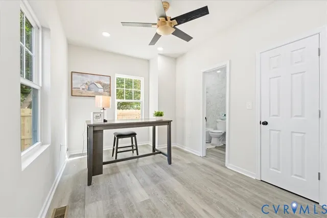 a view of a workspace with furniture and window