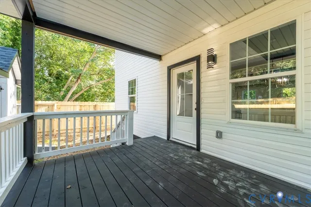 a view of a house with wooden deck