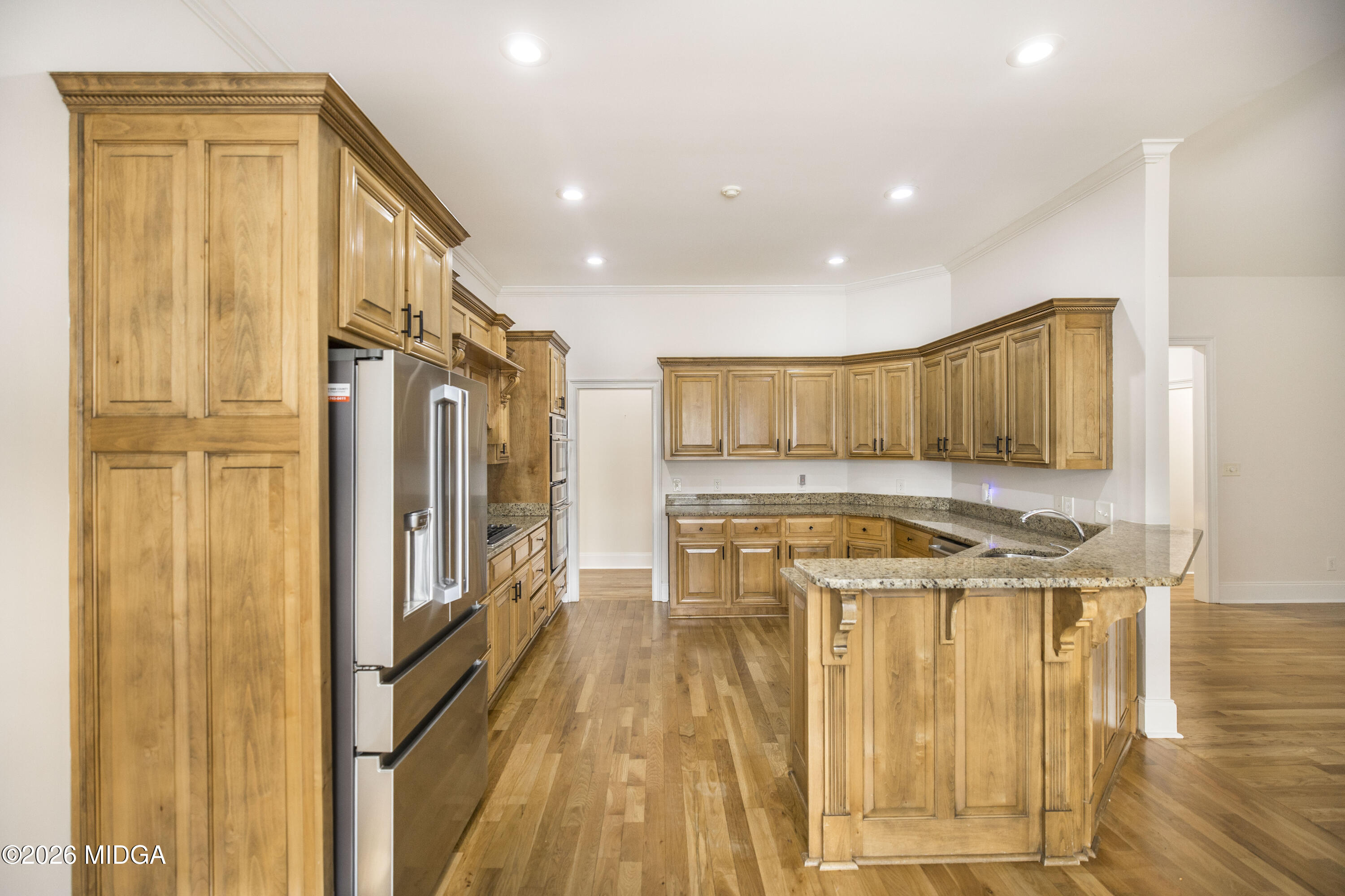720 Latrobe Way Macon, GA 31220 - Photo 19 of 52 a kitchen with stainless steel appliances granite countertop a refrigerator a stove and a wooden floors