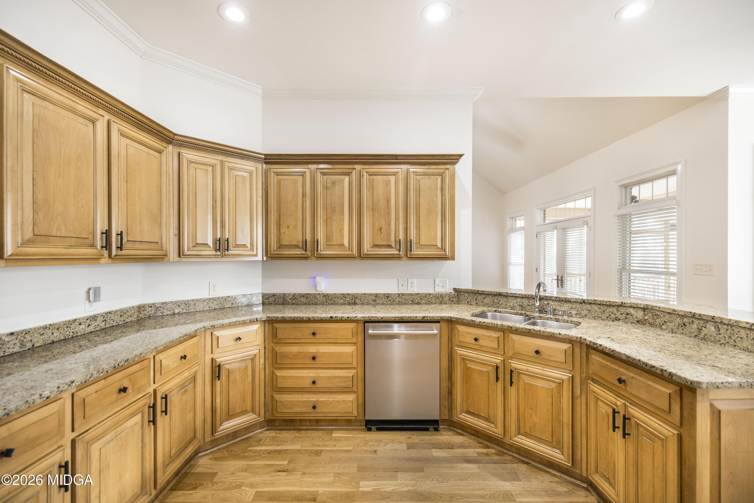 720 Latrobe Way Macon, GA 31220 - Photo 22 of 52 a large kitchen with granite countertop a sink a counter space appliances and cabinets
