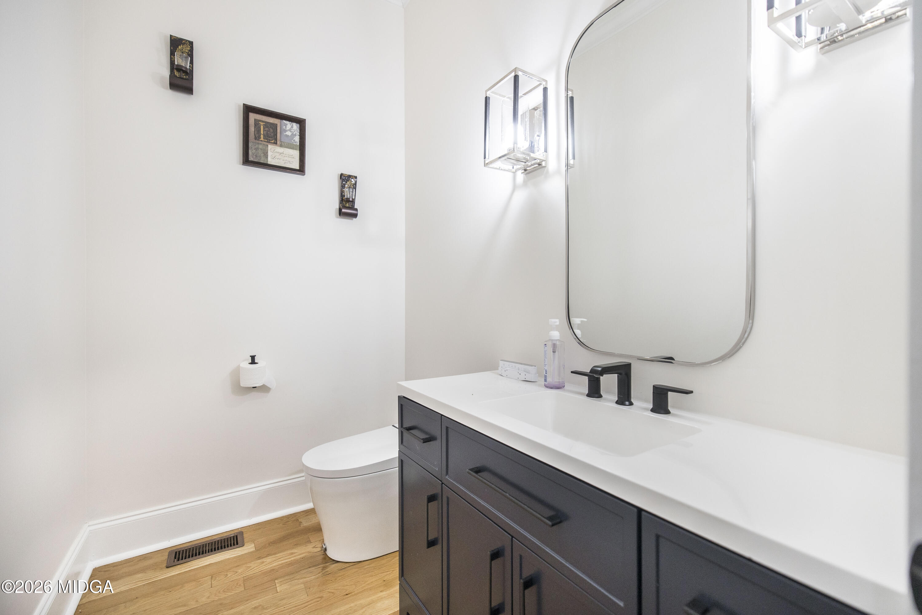 720 Latrobe Way Macon, GA 31220 - Photo 24 of 52 a bathroom with a sink a toilet and a mirror