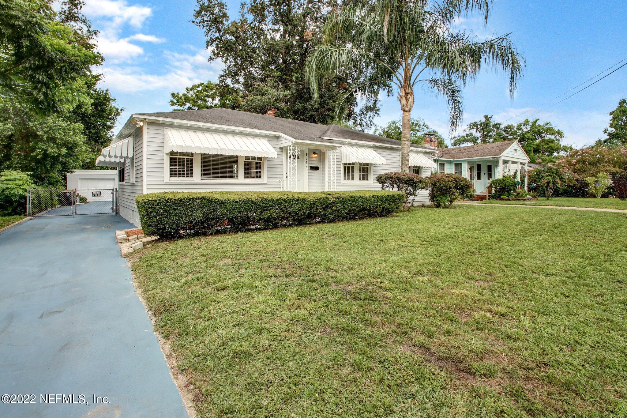 1743 Planters Road Jacksonville, FL 32207 - Photo 1 of 29 a front view of a house with a yard