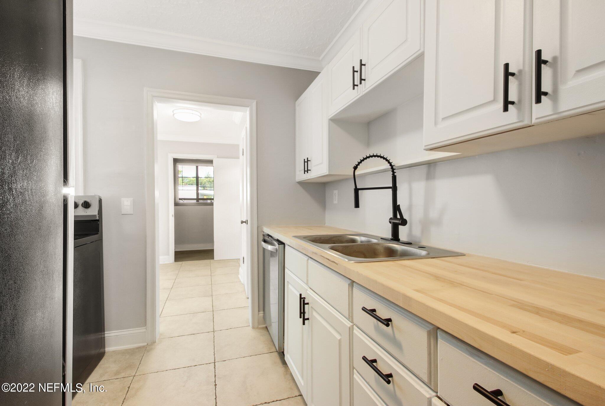 1743 Planters Road Jacksonville, FL 32207 - Photo 13 of 29 a kitchen with a sink and cabinets