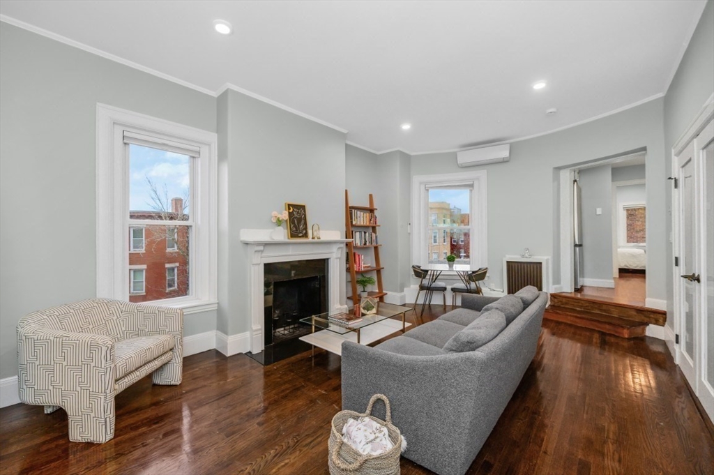 1880 Beacon Street, Unit 6 Brookline, MA 02445 - Photo 4 of 18 a living room with furniture and a fireplace