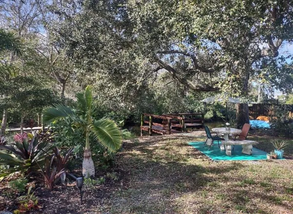 a view of a chairs and table in a backyard