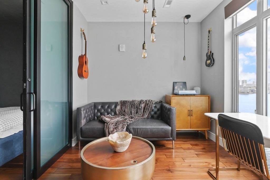 99 Sumner Street, Unit 623 Boston, MA 02128 - Photo 3 of 15 a living room with furniture and a window