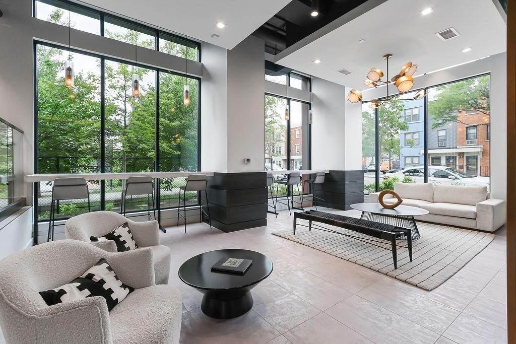 99 Sumner Street, Unit 623 Boston, MA 02128 - Photo 10 of 15 a living room with furniture and a large window