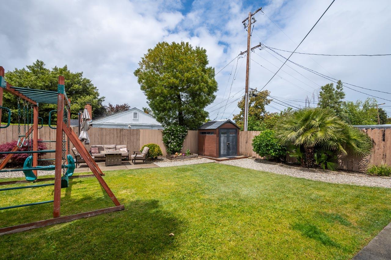 381 Old County Road San Carlos, CA 94070 - Photo 20 of 23 a view of a house with a yard and a patio