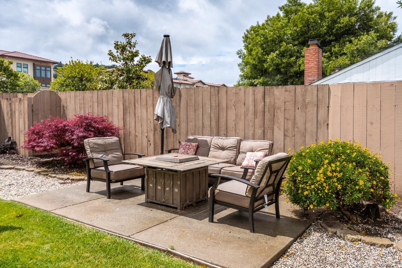 381 Old County Road San Carlos, CA 94070 - Photo 22 of 23 a backyard of a house with dining table and chairs with plants