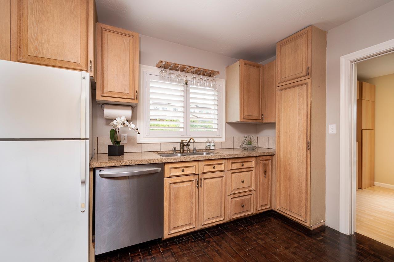 381 Old County Road San Carlos, CA 94070 - Photo 10 of 23 a kitchen with stainless steel appliances granite countertop a sink and cabinets with wooden floor